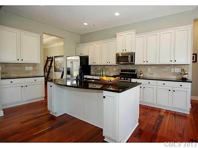 1705 Ridgehaven Road, Unit 230 Waxhaw, NC 28173 - Photo 5 of 16 a kitchen with granite countertop a refrigerator stove top oven and sink