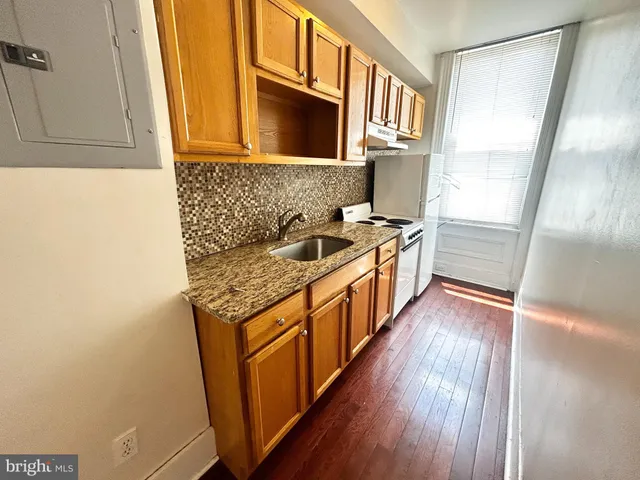 a kitchen with stainless steel appliances granite countertop a stove and a refrigerator