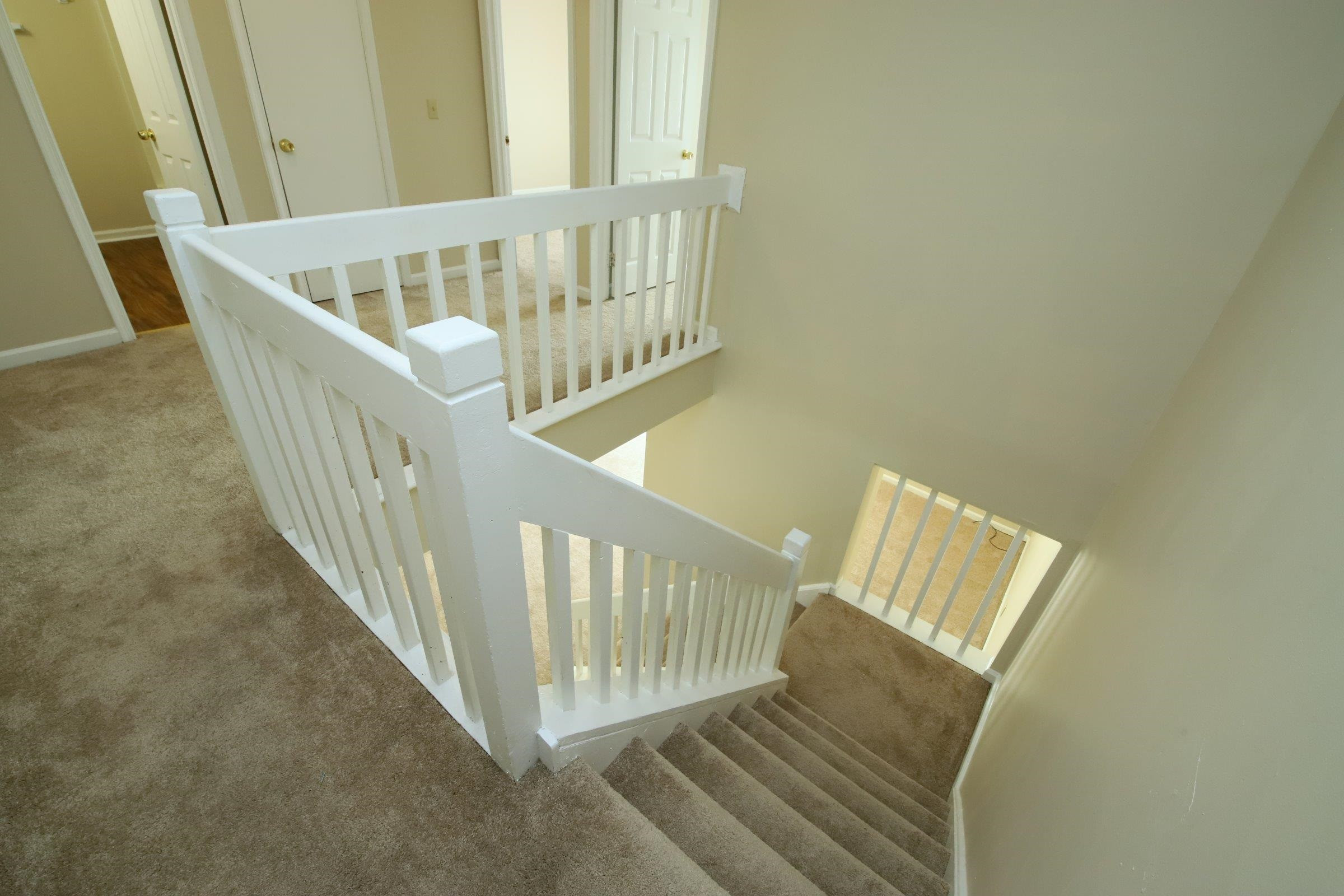 1227 Seaton Road, Unit 56 Durham, NC 27713 - Photo 15 of 30 a view of staircase with railing and white walls