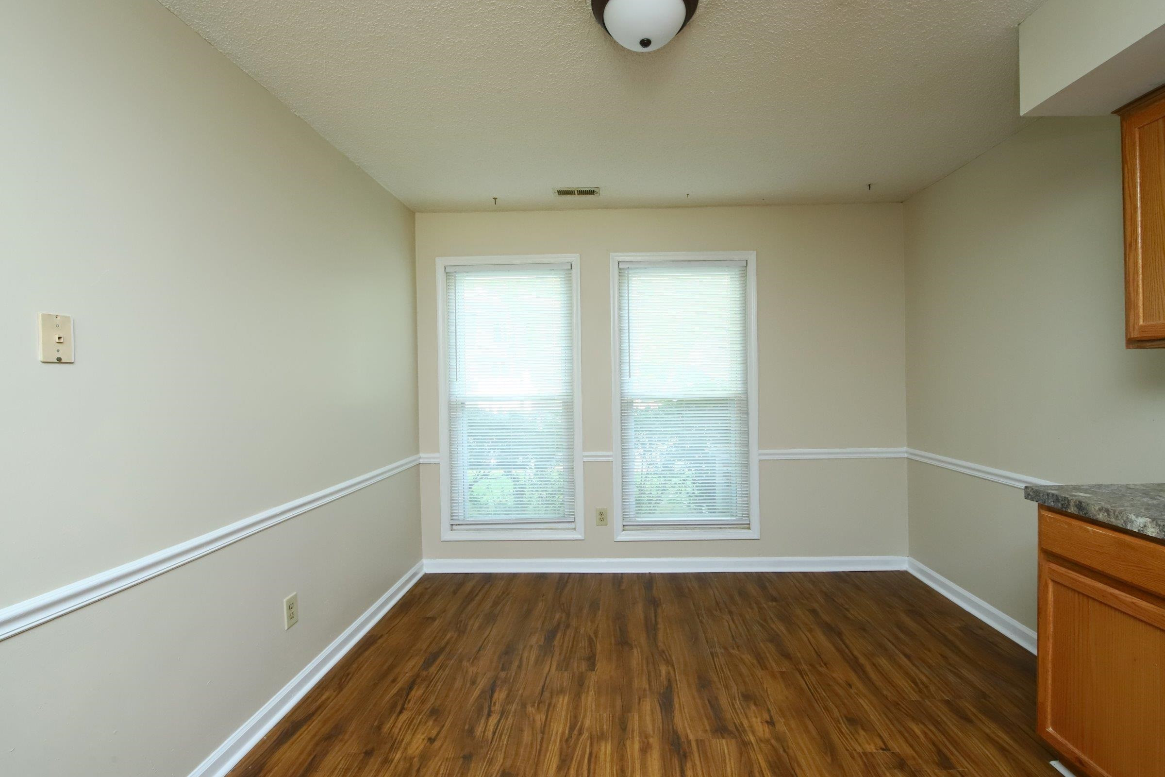 1227 Seaton Road, Unit 56 Durham, NC 27713 - Photo 6 of 30 a view of an empty room with wooden floor and a window