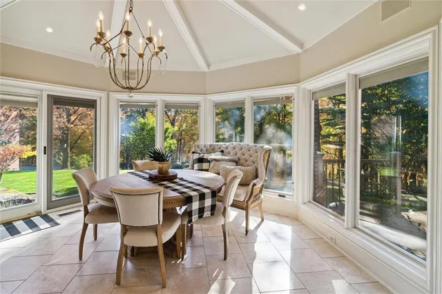 a view of a dining room with furniture large windows and wooden floor