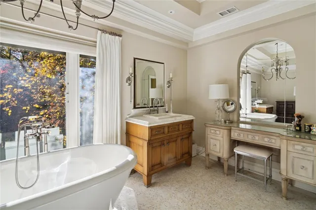 a en suite bathroom with a granite countertop sink and a mirror