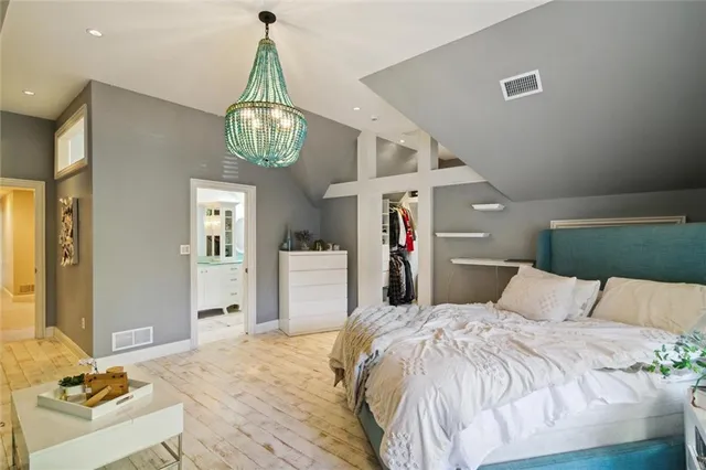 a bedroom with a bed and chandelier