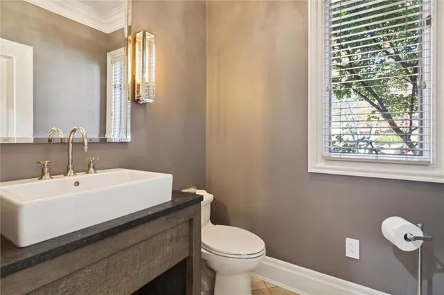 a bathroom with a sink a toilet and a mirror