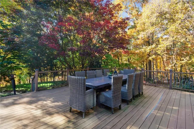 a view of backyard with deck and outdoor seating