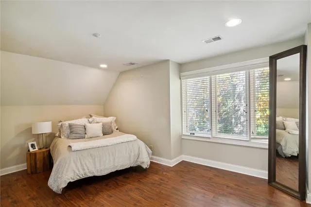 a bathroom with a toilet a sink and a mirror