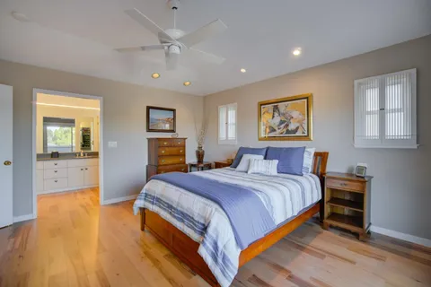 a spacious bedroom with a bed and a chandelier