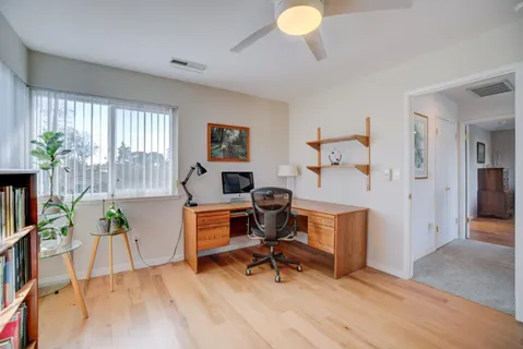 a workspace with furniture and a wooden floor