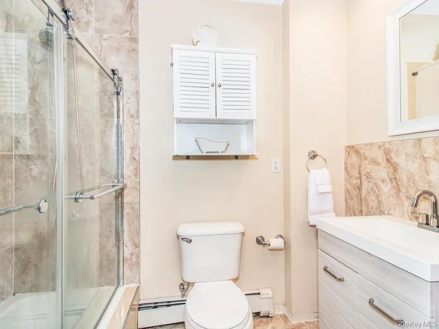 a bathroom with a toilet a sink and a shower