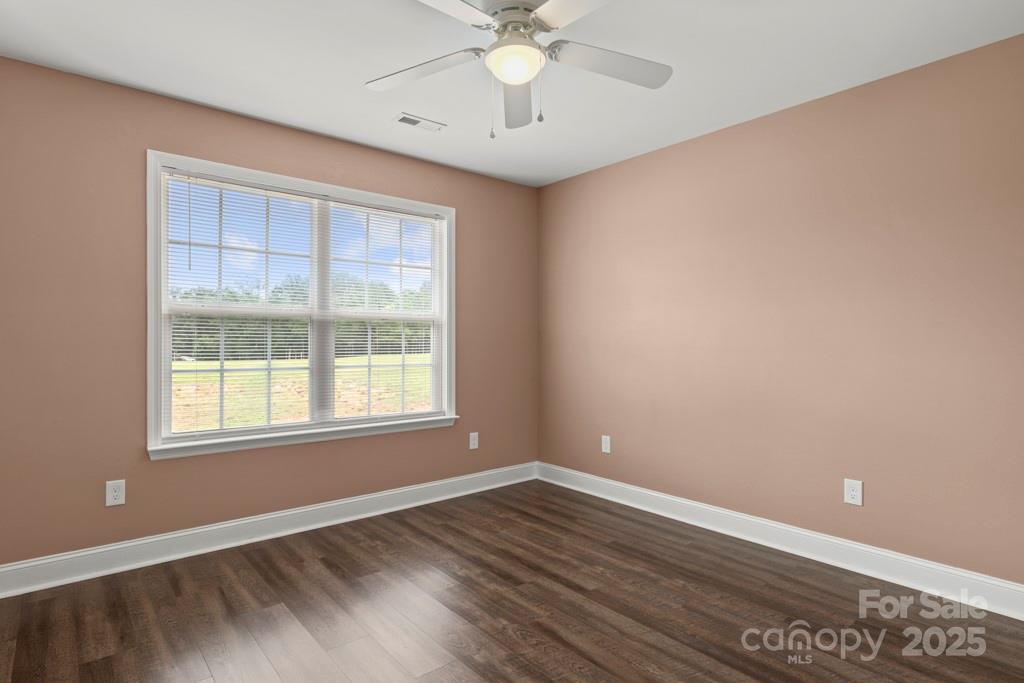 4268 Fletcher Funderburk Road Lancaster, SC 29720 - Photo 11 of 26 a view of an empty room with wooden floor and a window