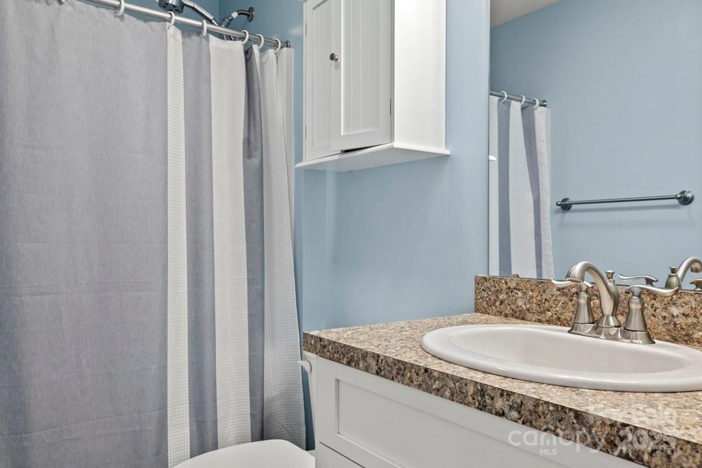 4268 Fletcher Funderburk Road Lancaster, SC 29720 - Photo 12 of 26 a bathroom with a granite countertop sink and a mirror