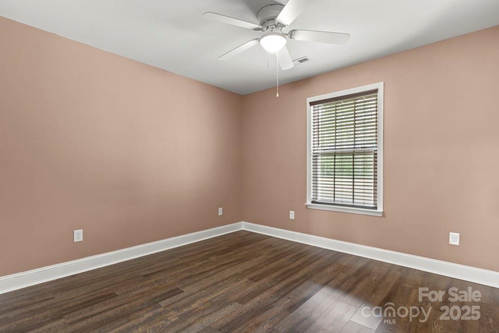4268 Fletcher Funderburk Road Lancaster, SC 29720 - Photo 13 of 26 a view of an empty room with wooden floor and a window