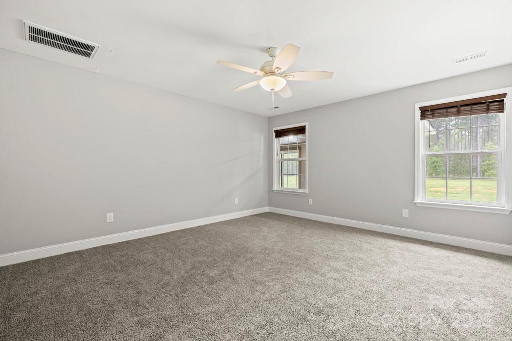 4268 Fletcher Funderburk Road Lancaster, SC 29720 - Photo 15 of 26 an empty room with windows and fan