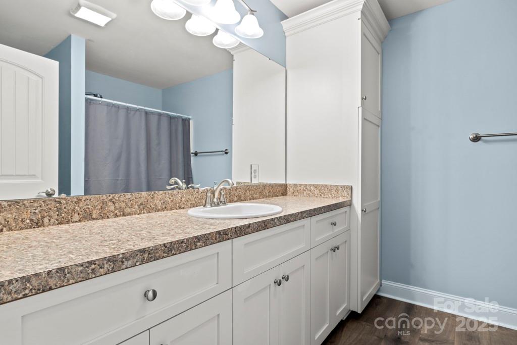 4268 Fletcher Funderburk Road Lancaster, SC 29720 - Photo 17 of 26 a bathroom with a granite countertop sink and a mirror