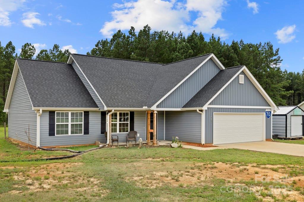 4268 Fletcher Funderburk Road Lancaster, SC 29720 - Photo 3 of 26 a view of a big house with a big yard and potted plants