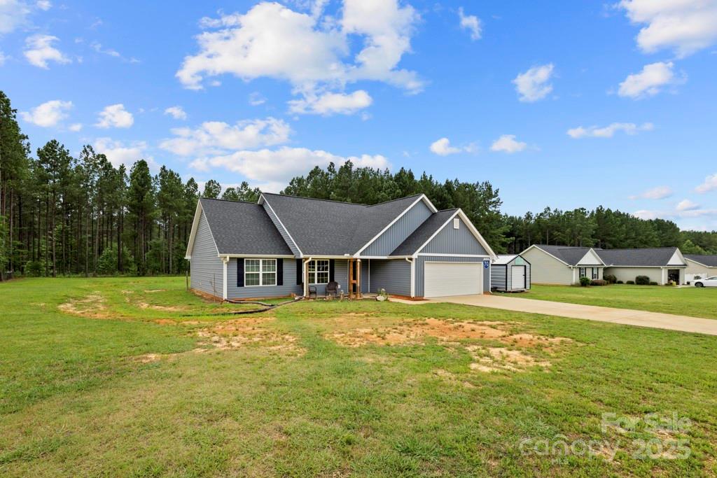 4268 Fletcher Funderburk Road Lancaster, SC 29720 - Photo 4 of 26 a view of a big house with a big yard and large trees