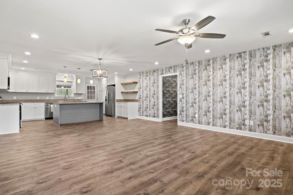 4268 Fletcher Funderburk Road Lancaster, SC 29720 - Photo 5 of 26 a view of an empty room with wooden floor and a kitchen