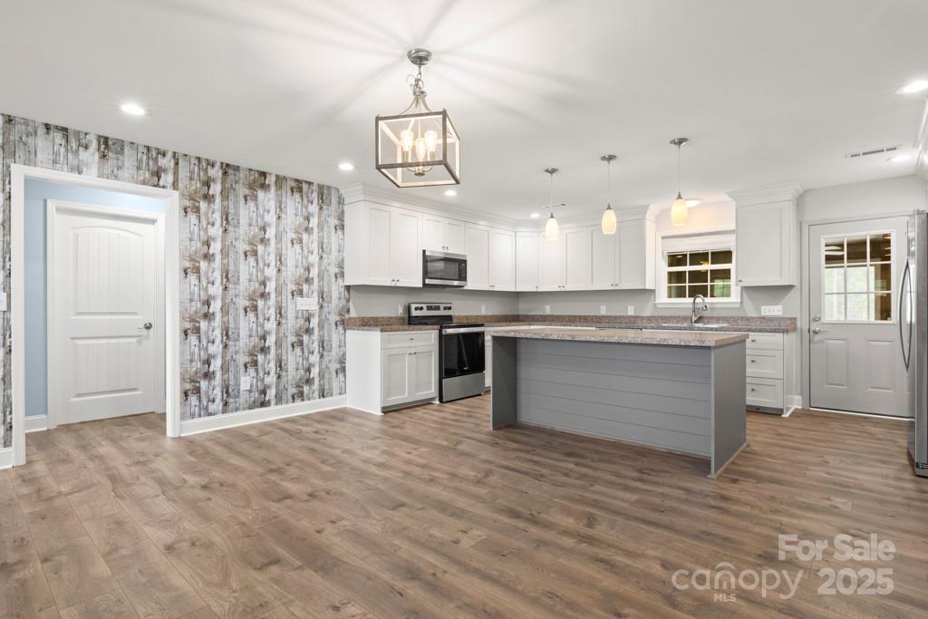 4268 Fletcher Funderburk Road Lancaster, SC 29720 - Photo 6 of 26 a large kitchen with cabinets and stainless steel appliances