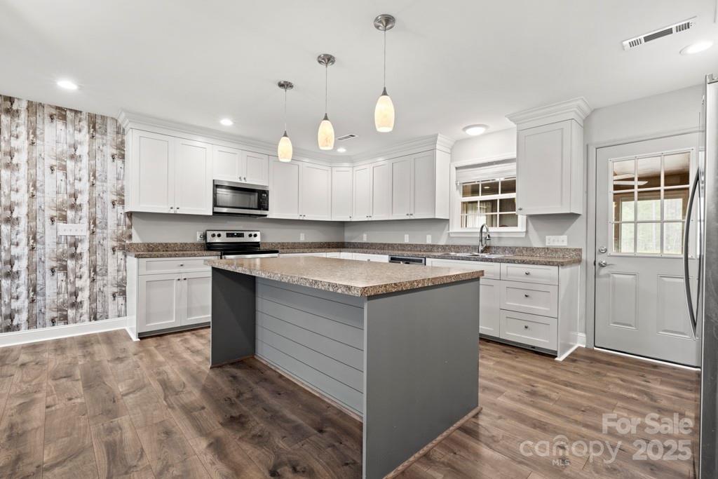 4268 Fletcher Funderburk Road Lancaster, SC 29720 - Photo 7 of 26 a kitchen with granite countertop a sink cabinets and stainless steel appliances