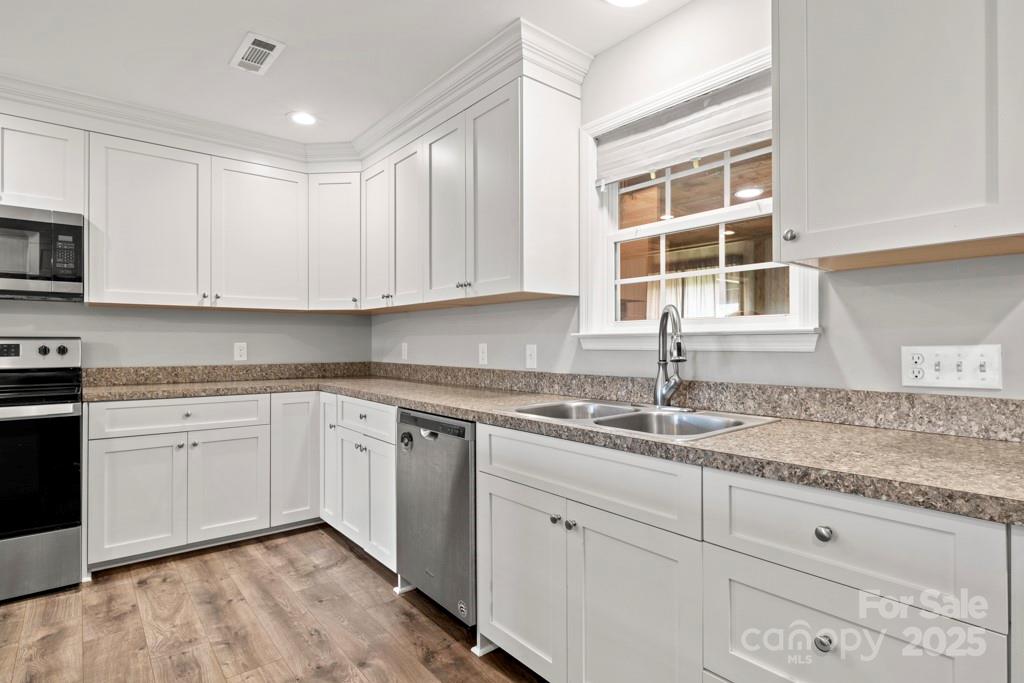 4268 Fletcher Funderburk Road Lancaster, SC 29720 - Photo 8 of 26 a kitchen with granite countertop white cabinets stainless steel appliances a sink and dishwasher