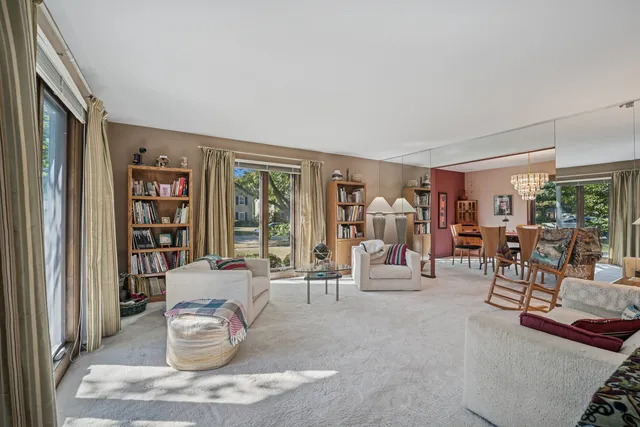 a living room filled with furniture and large window