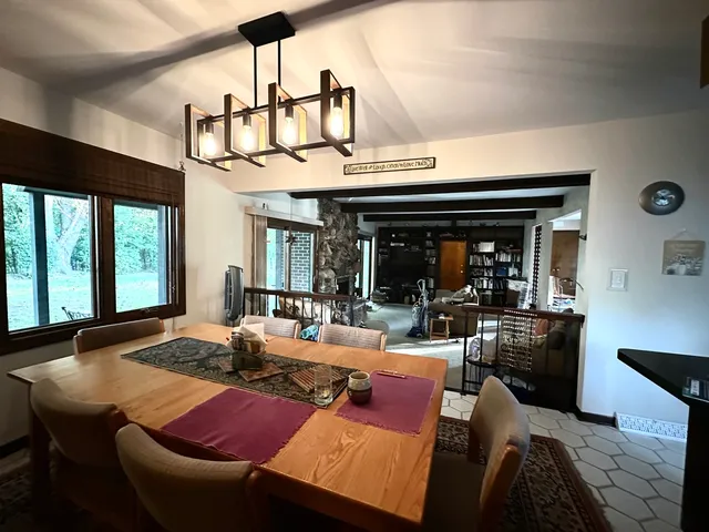 a view of a dining room with furniture window and outside view