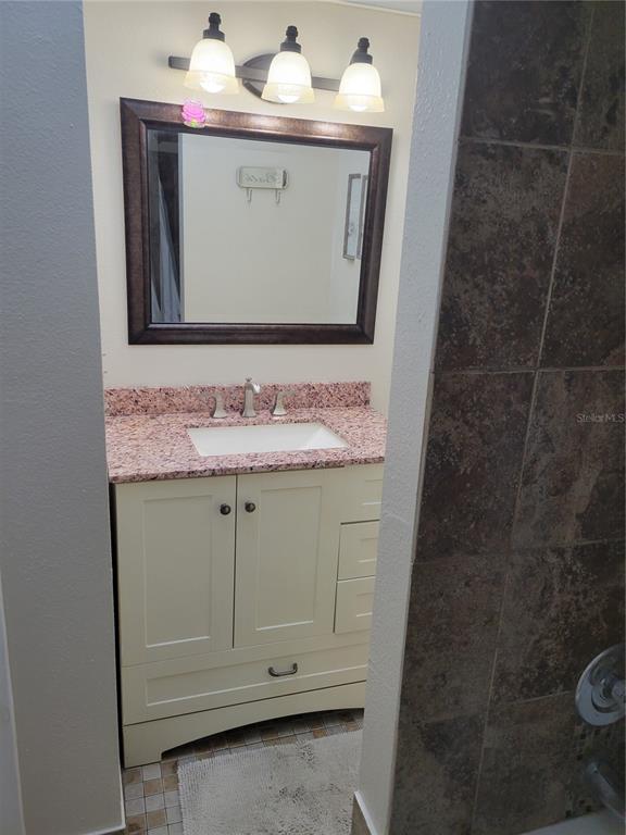 10038 62nd Avenue North, Unit 11 St. Petersburg, FL 33708 - Photo 11 of 43 a bathroom with a sink and a mirror