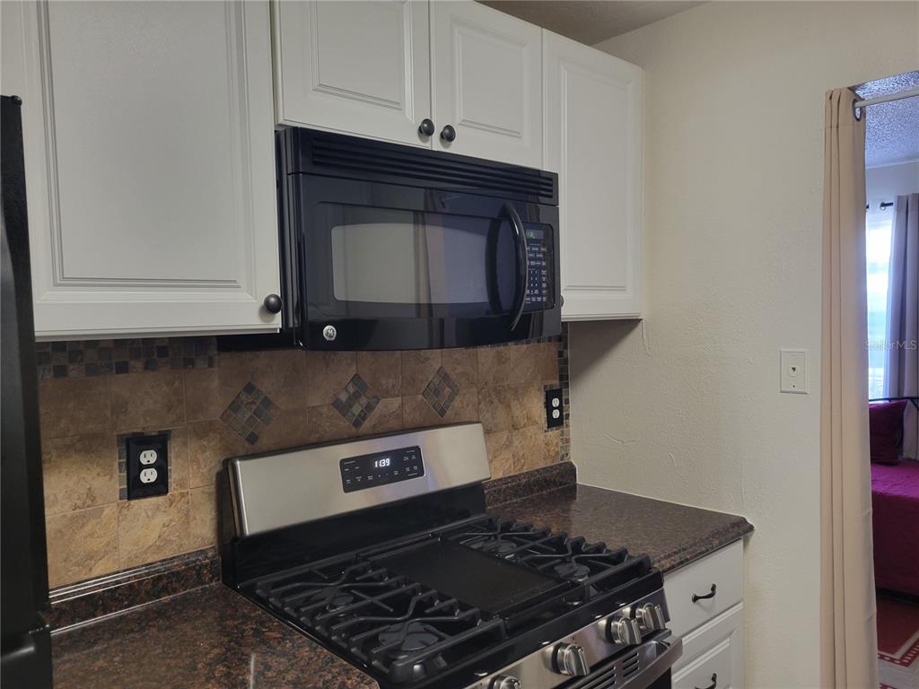 10038 62nd Avenue North, Unit 11 St. Petersburg, FL 33708 - Photo 17 of 43 a stove top oven sitting inside of a kitchen