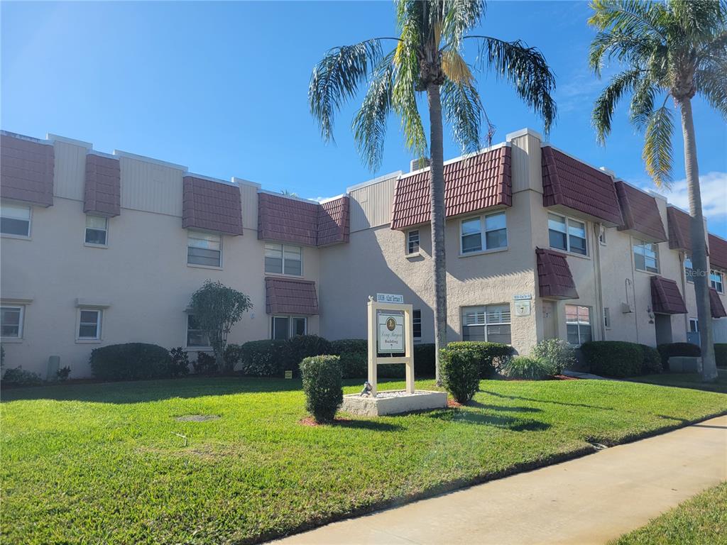 10038 62nd Avenue North, Unit 11 St. Petersburg, FL 33708 - Photo 36 of 43 a view of a house with a yard