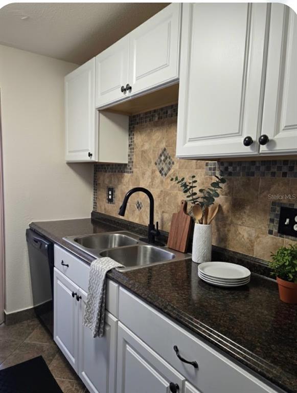 10038 62nd Avenue North, Unit 11 St. Petersburg, FL 33708 - Photo 4 of 43 a kitchen with granite countertop a sink a stove and cabinets