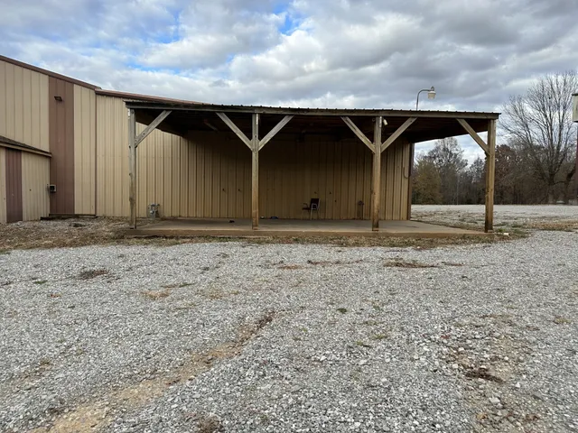 a view of house with backyard
