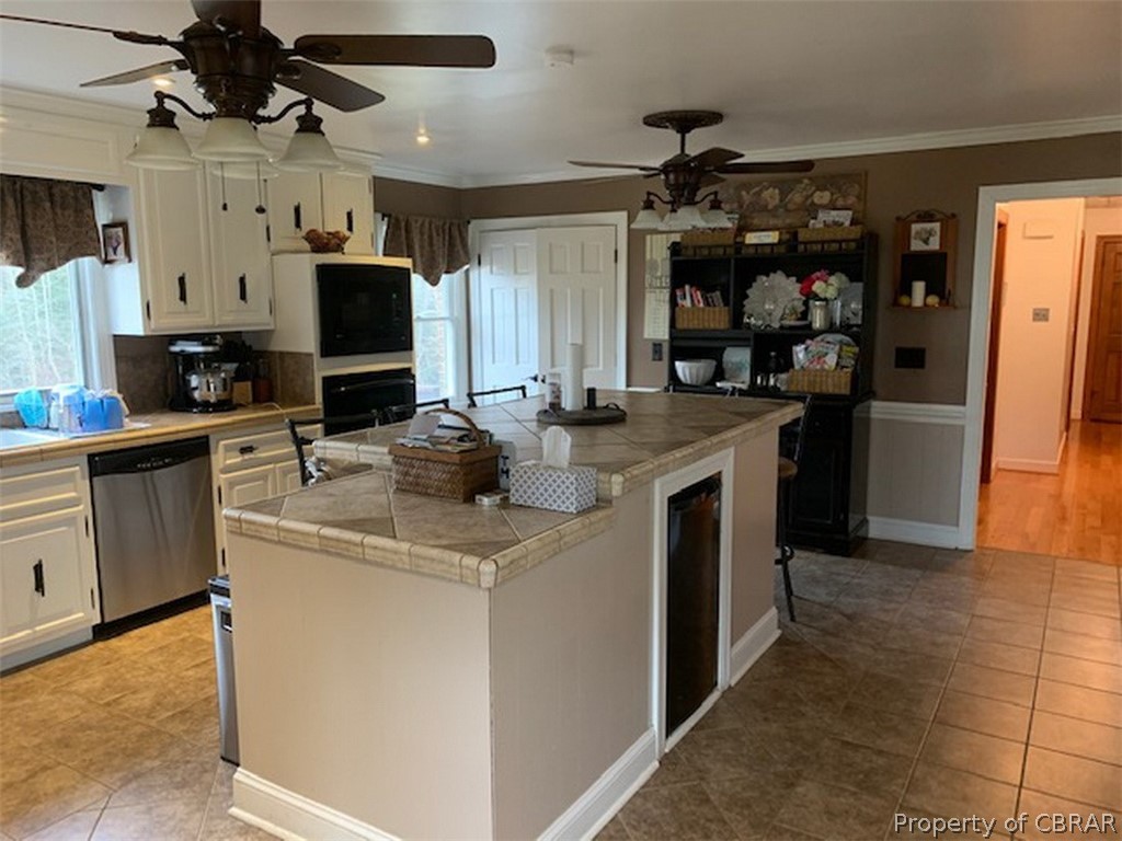 Kitchen with tile floors, tile counters and updated appliances