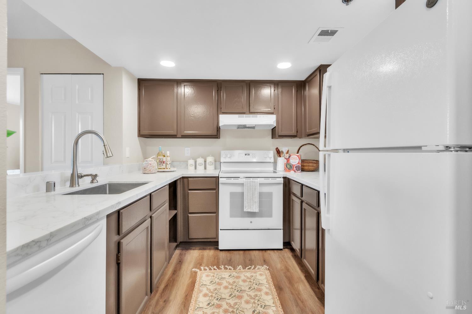 202 Mariner Way Novato, CA 94945 - Photo 7 of 27 a kitchen with a refrigerator sink and cabinets