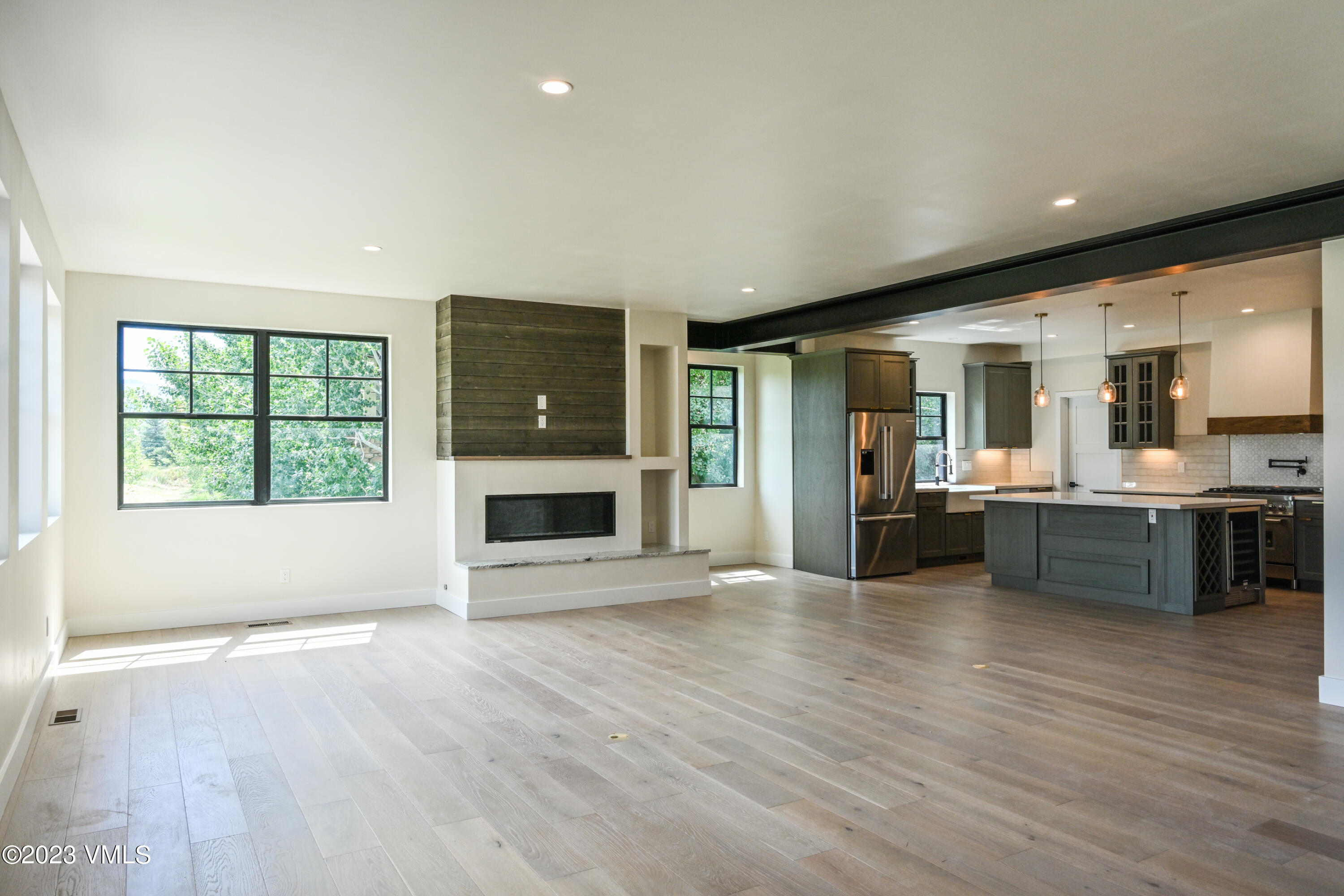 207 Aidan Road Eagle, CO 81631 - Photo 11 of 26 an open kitchen with a refrigerator and a stove top oven