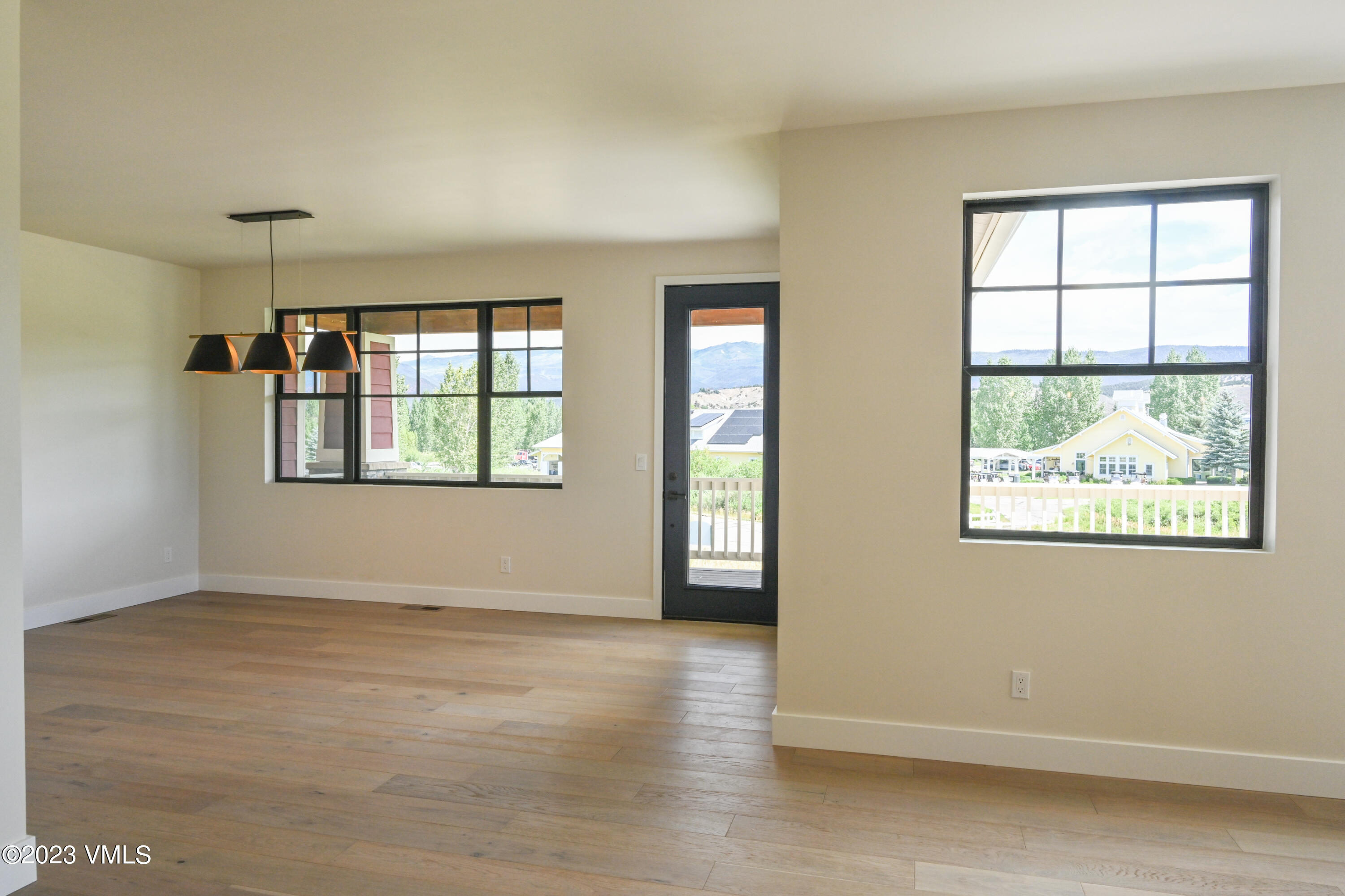 207 Aidan Road Eagle, CO 81631 - Photo 13 of 26 an empty room with wooden floor and windows