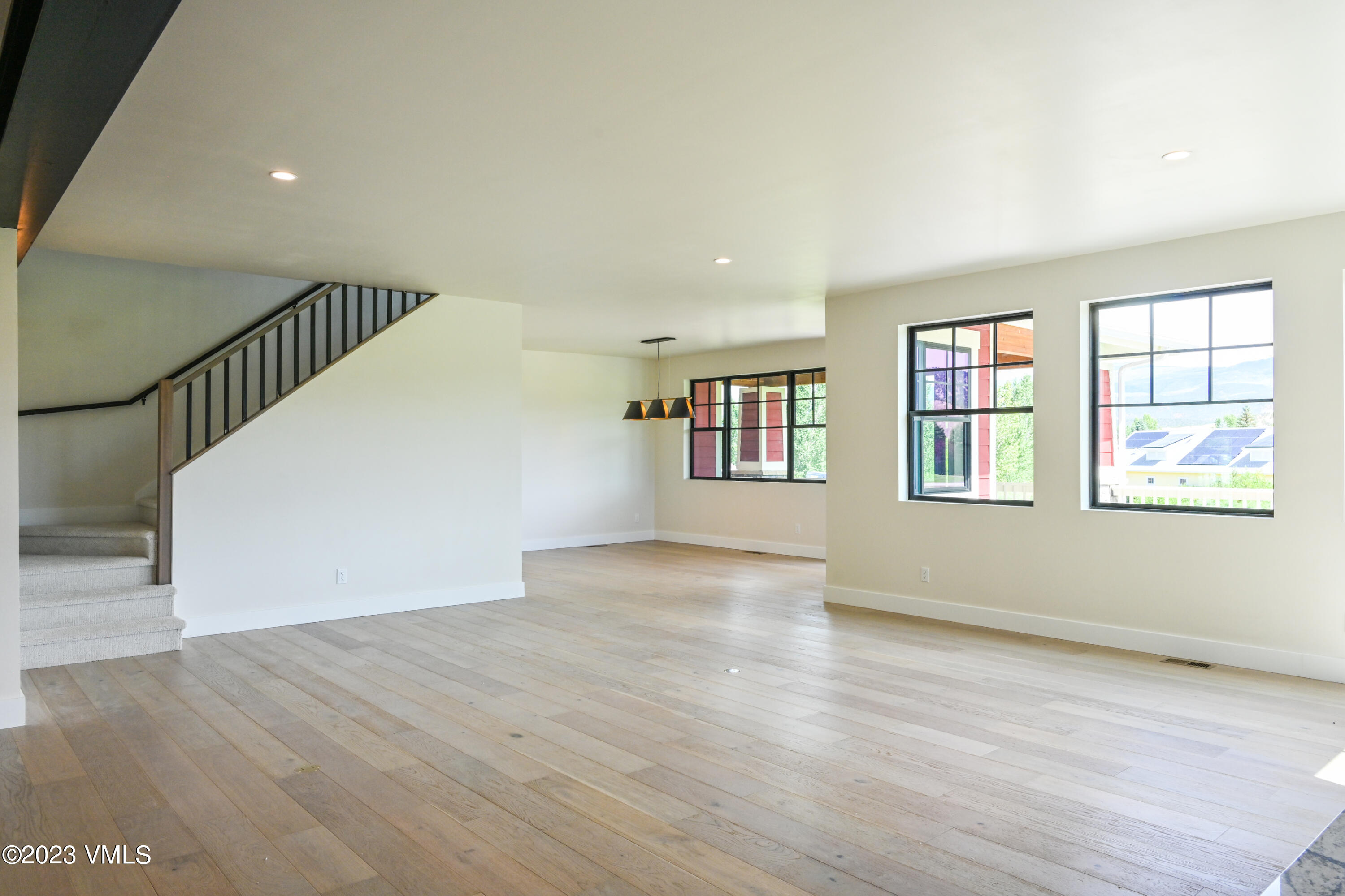 207 Aidan Road Eagle, CO 81631 - Photo 14 of 26 a view of an empty room with wooden floor and a window