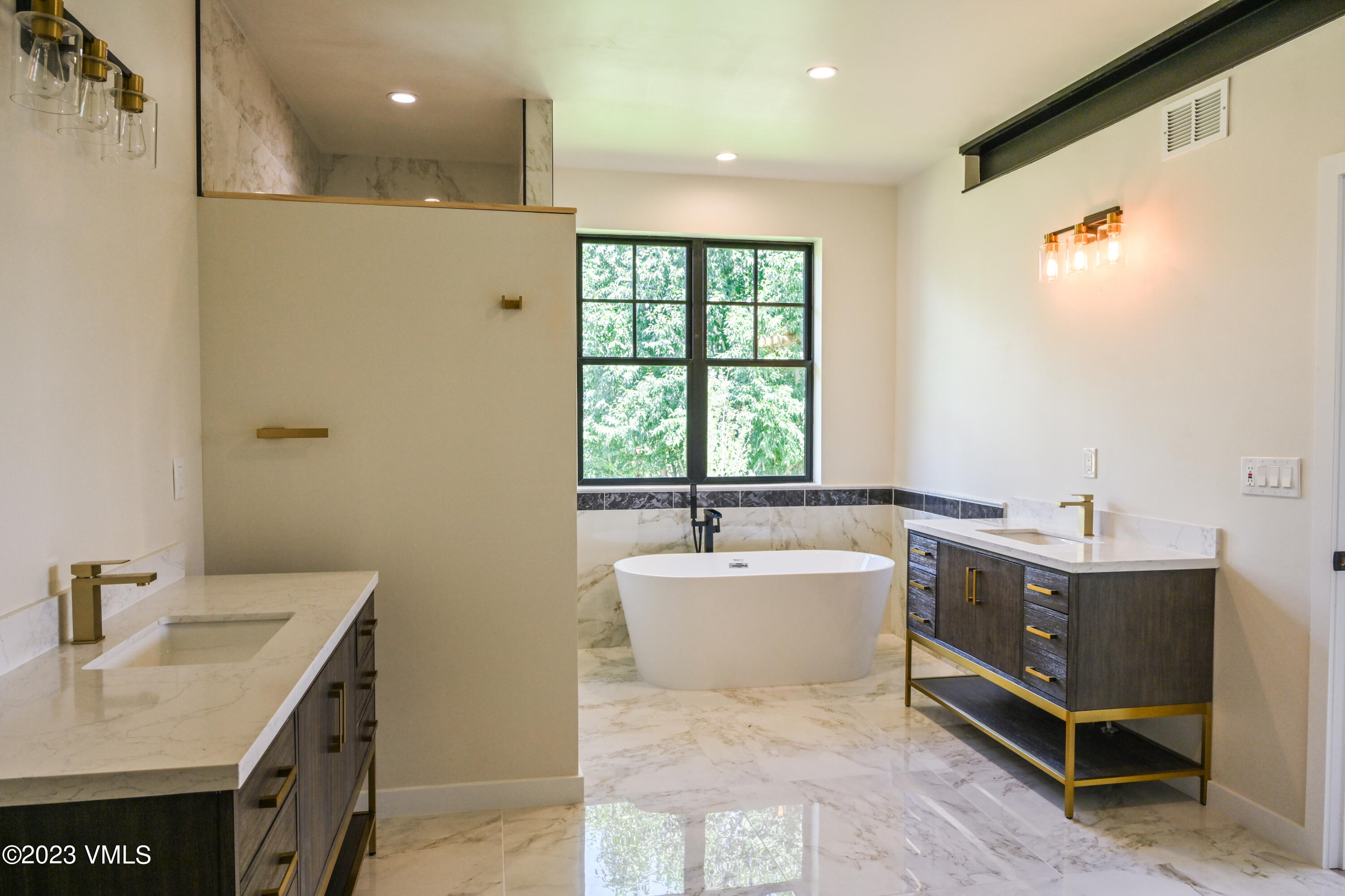 207 Aidan Road Eagle, CO 81631 - Photo 15 of 26 a spacious bathroom with a tub sink and mirror