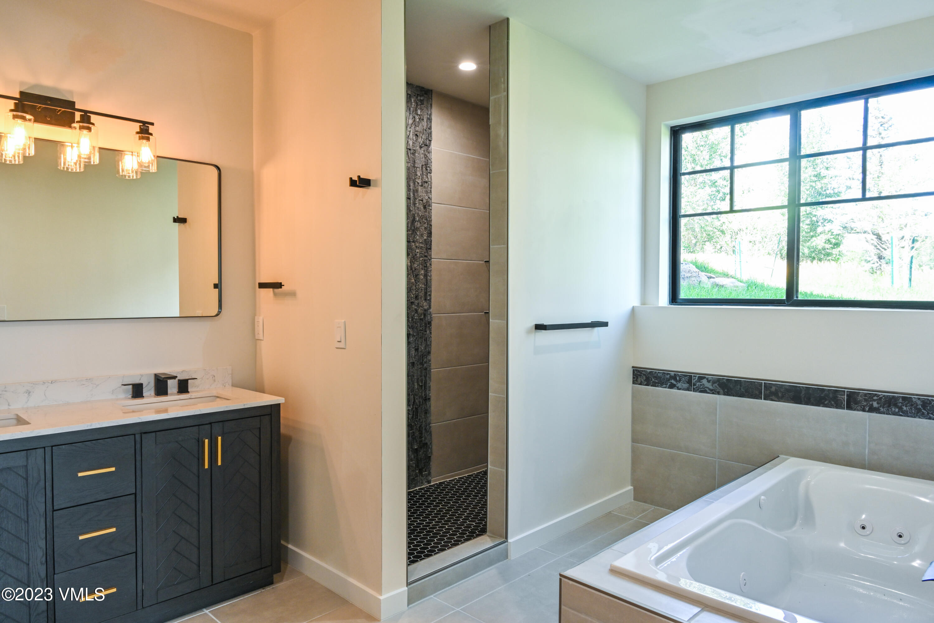 207 Aidan Road Eagle, CO 81631 - Photo 18 of 26 a bathroom with a tub sink and mirror