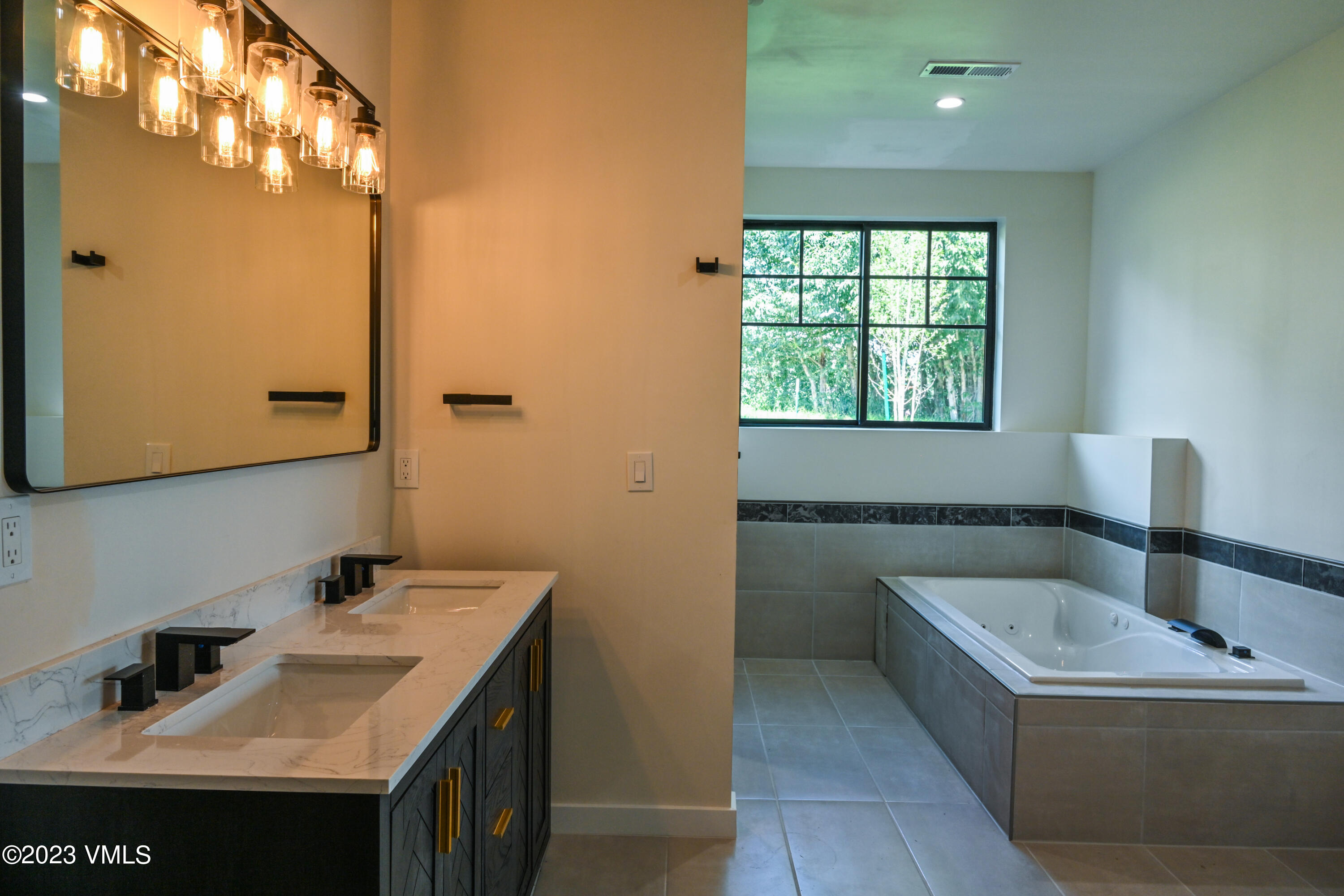 207 Aidan Road Eagle, CO 81631 - Photo 19 of 26 a bathroom with a tub sink and mirror
