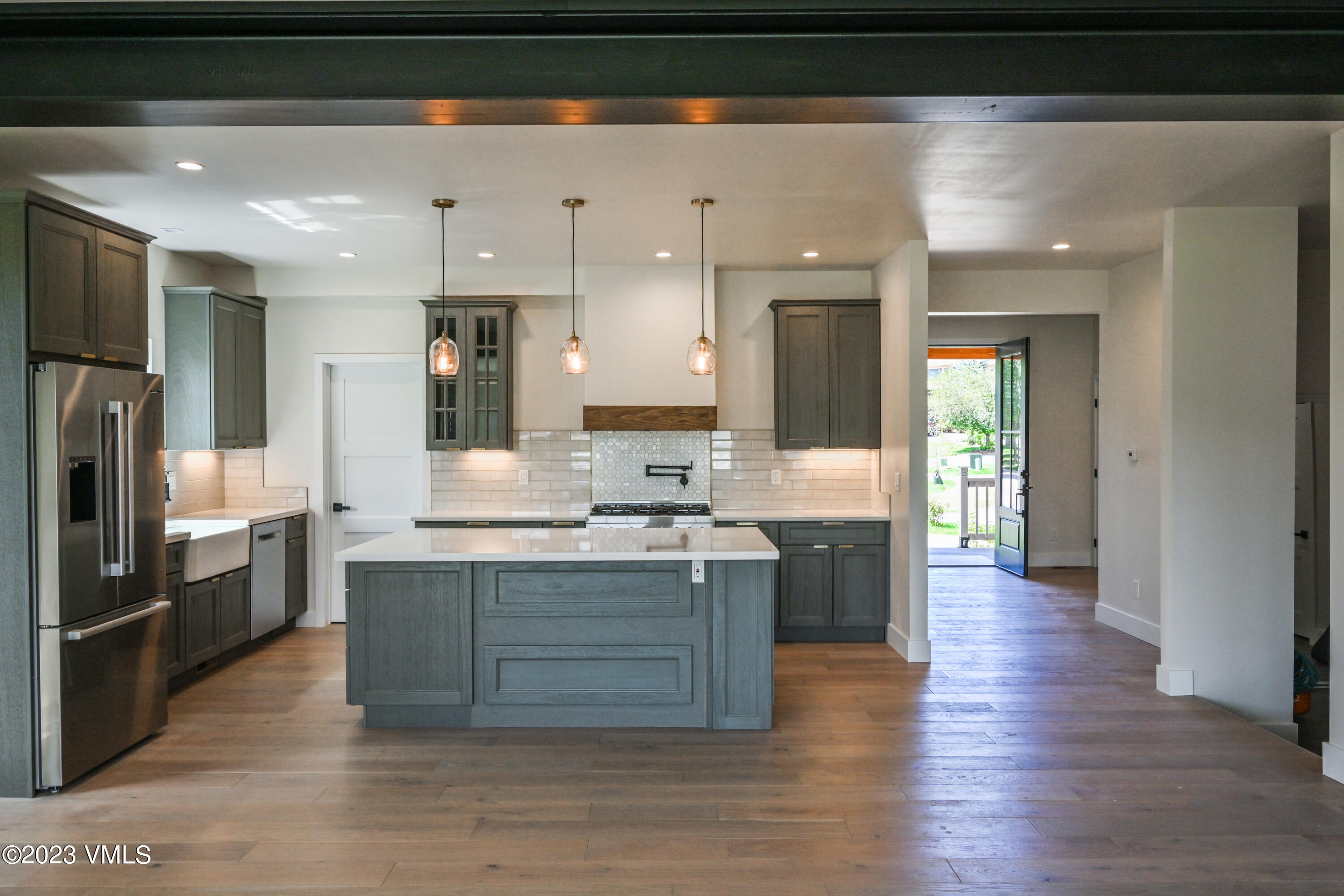 207 Aidan Road Eagle, CO 81631 - Photo 9 of 26 a large kitchen with granite countertop a large counter top stainless steel appliances and cabinets