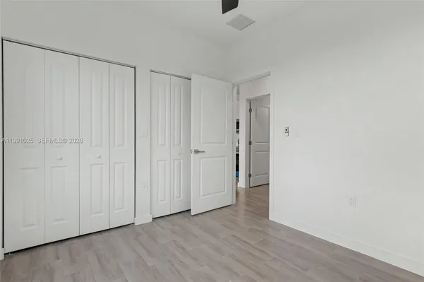 a view of a room with wooden floor