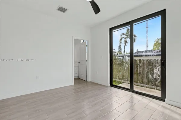 a view of an empty room with glass door