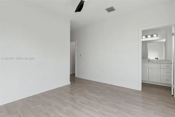 a view of a room with wooden floor