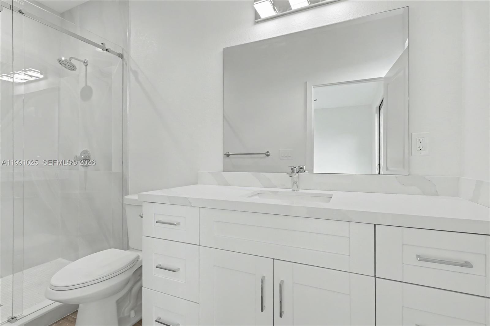 6140 Southwest 39th Street Miramar, FL 33023 - Photo 27 of 40 a bathroom with a sink toilet vanity and shower