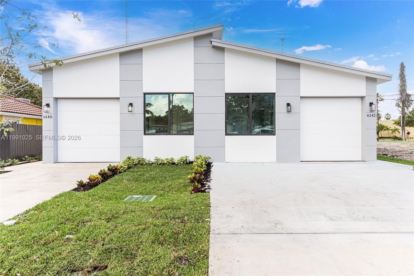 6140 Southwest 39th Street Miramar, FL 33023 - Photo 3 of 40 a front view of a house with garden
