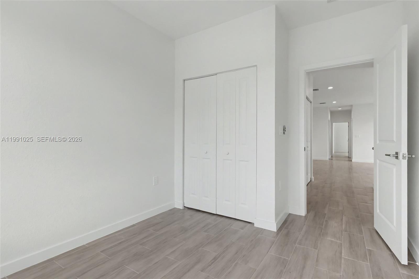 6140 Southwest 39th Street Miramar, FL 33023 - Photo 34 of 40 a view of a hallway with wooden floor
