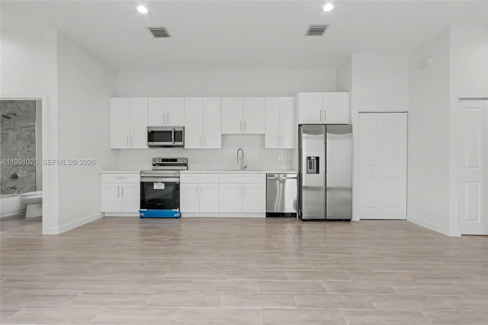 6140 Southwest 39th Street Miramar, FL 33023 - Photo 37 of 40 a view of kitchen with stainless steel appliances wooden cabinets and entryway