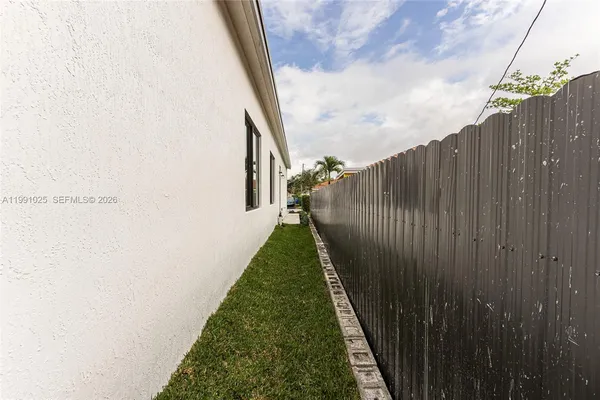 a view of a backyard with pathway