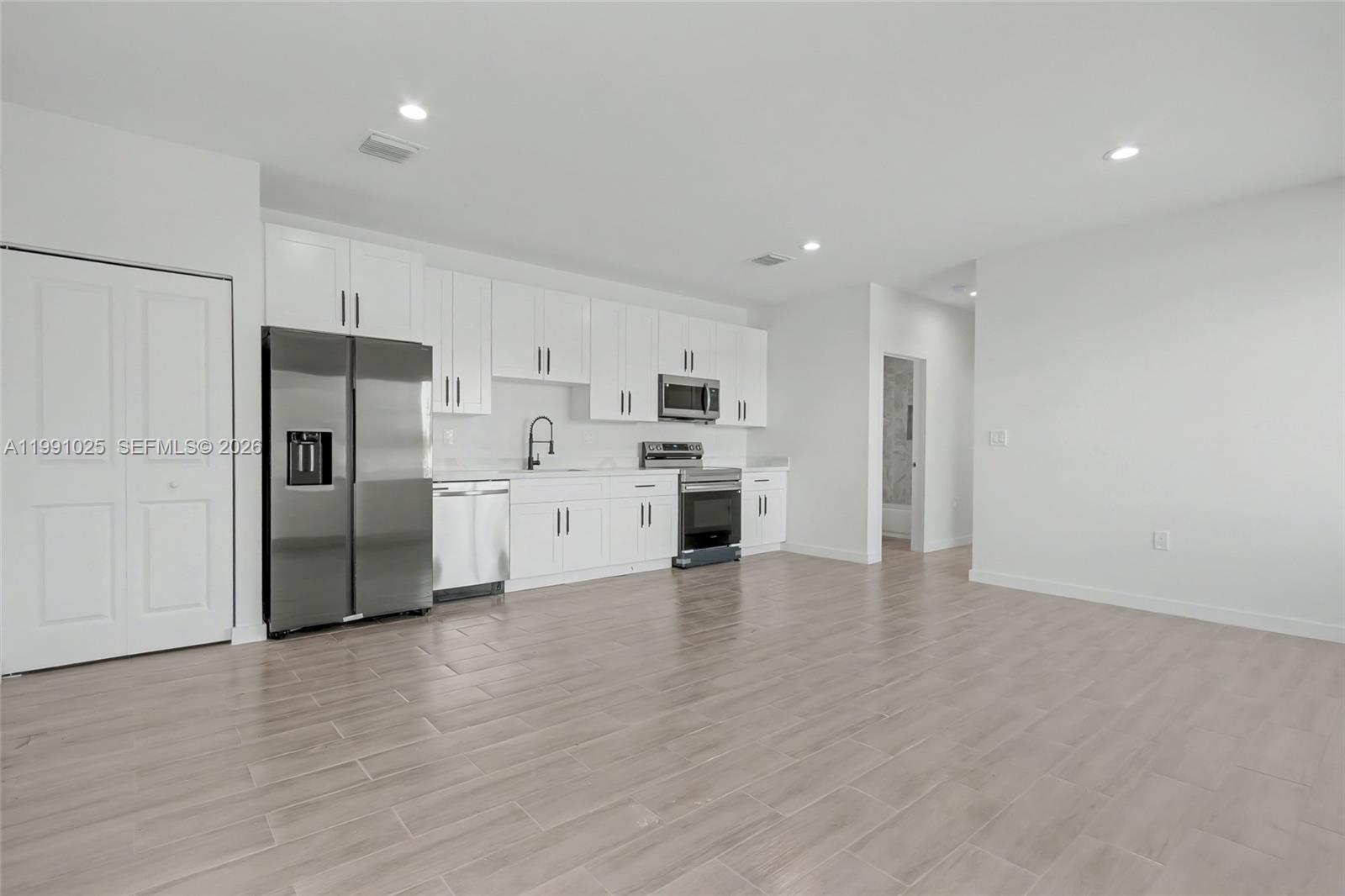6140 Southwest 39th Street Miramar, FL 33023 - Photo 9 of 40 a kitchen with stainless steel appliances a refrigerator and a stove top oven