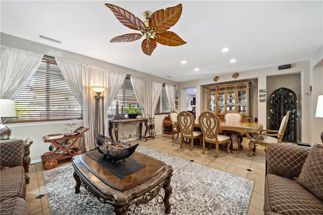 a kitchen with a dining table chairs and refrigerator